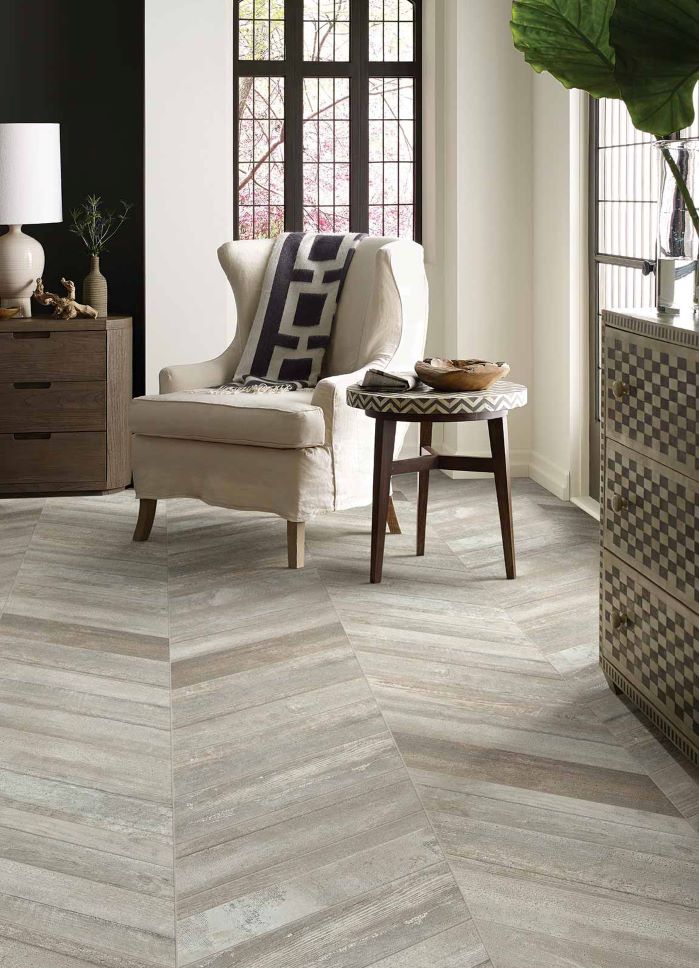 Herringbone wood look tile in a classy earth-toned living space