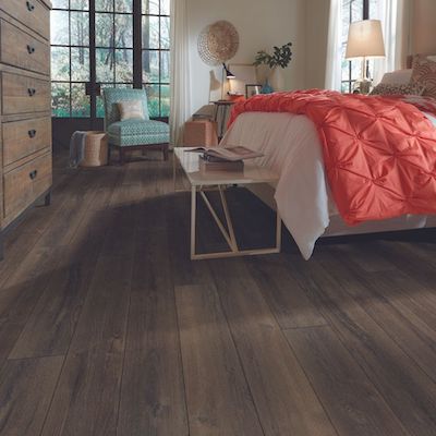 dark stained luxury vinyl plank in a bedroom
